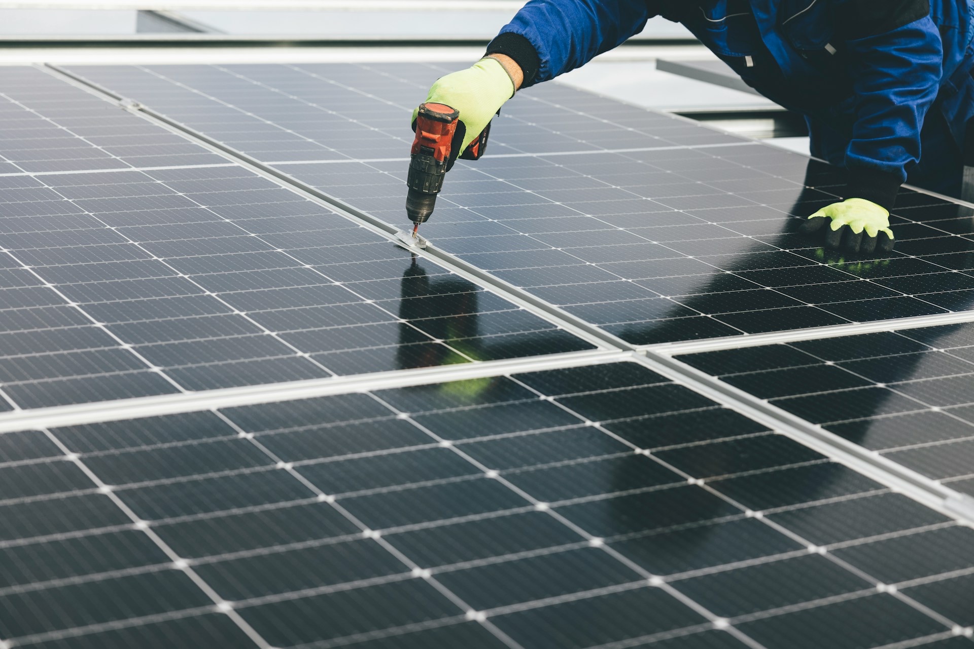 A SolarMitras technician installing rooftop solar panels